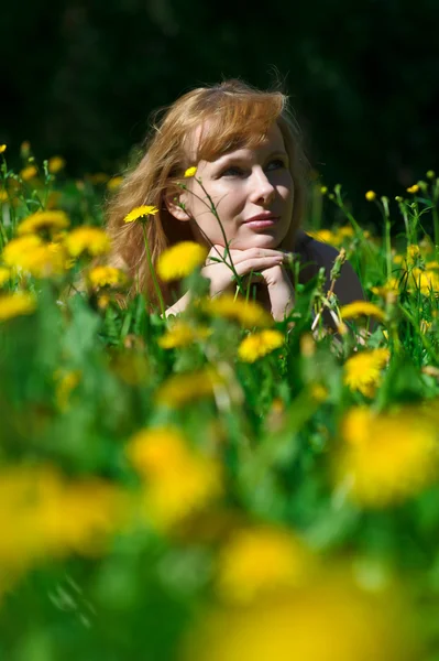Young pretty woman in wreath of dandelions in the meadow solar day — Stock Photo, Image