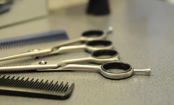 Comb, scissors on the table close-up. Royalty Free Stock Photos