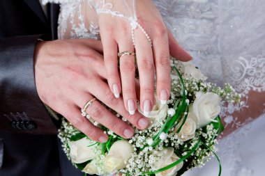 Hands and rings on wedding bouquet clipart