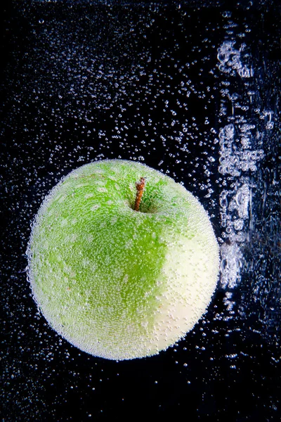 Mela verde intera e fetta in acqua — Foto Stock