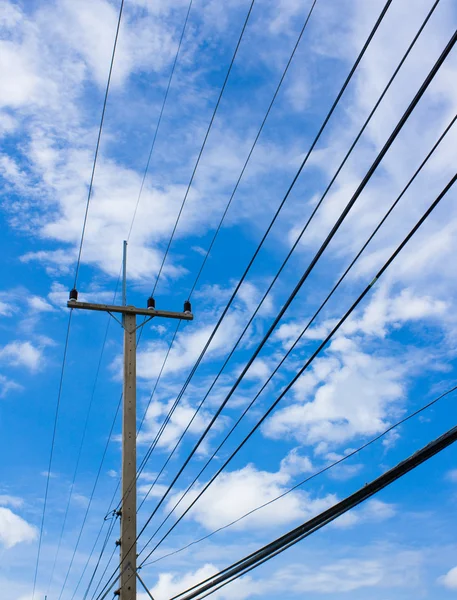 Линии электропередач на голубом небе с облачным фоном — стоковое фото