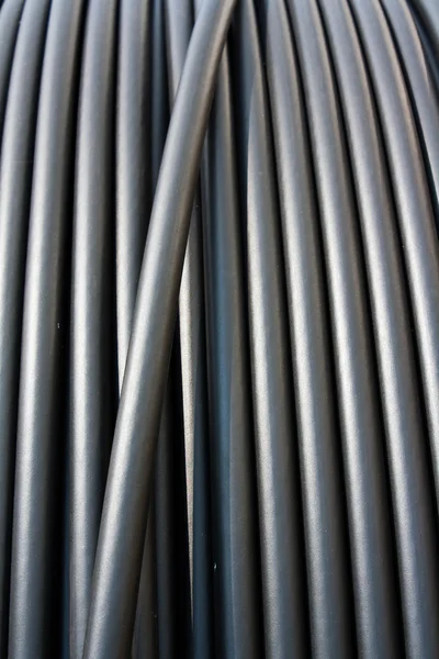 Stock image Close-up of black electricity cable vertical on a spool.