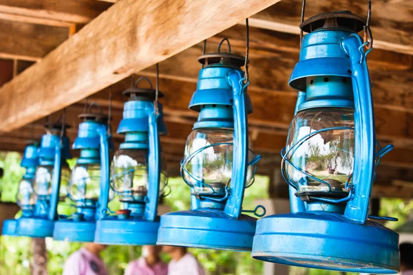 Perspective view of storm lanterns hanged on wooden counterpoise — Stock Photo, Image