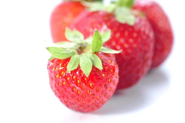 Three strawberries on a white background — Stock Photo, Image