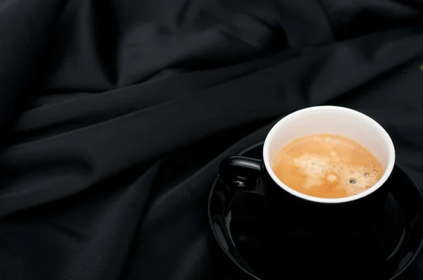 Šálek kávy na černé sukno — Stock fotografie