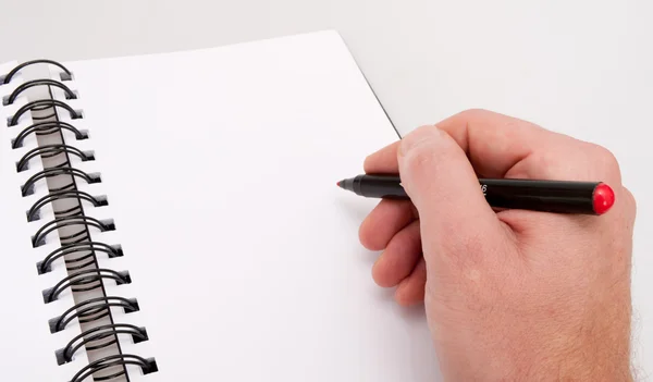 Notebook aberto e mão com marcador — Fotografia de Stock