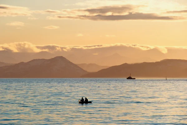 Fishermen boat in sunset — Stock Photo, Image