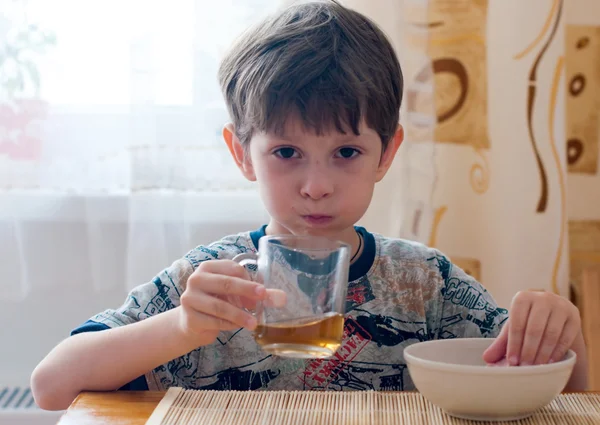 stock image The boy has breakfast