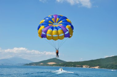 Paragliding on beach clipart