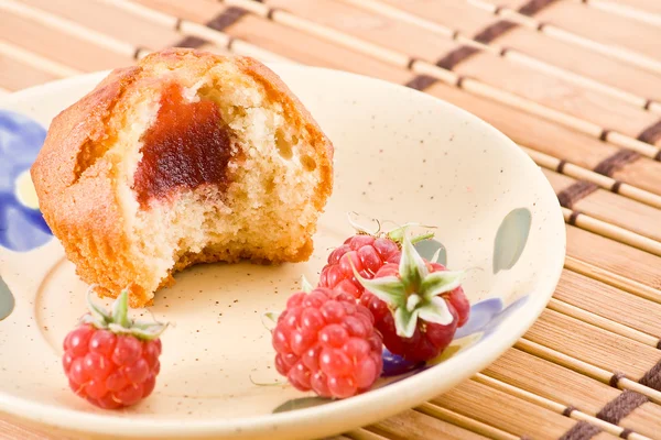 Bitten cake with raspberry jam.