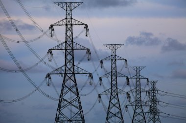 Electrical towers on blue sky background clipart