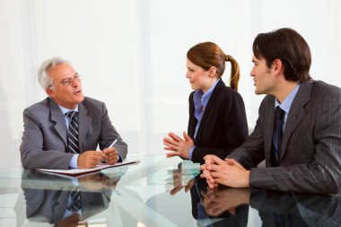 Two men and one woman during a job interview clipart