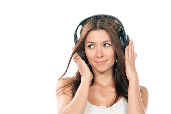 Mujer delgada escuchando y disfrutando de la música en los auriculares —  Fotos de Stock