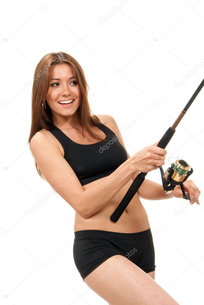 Sport woman holding a fishing rod with reel Stock Photo by