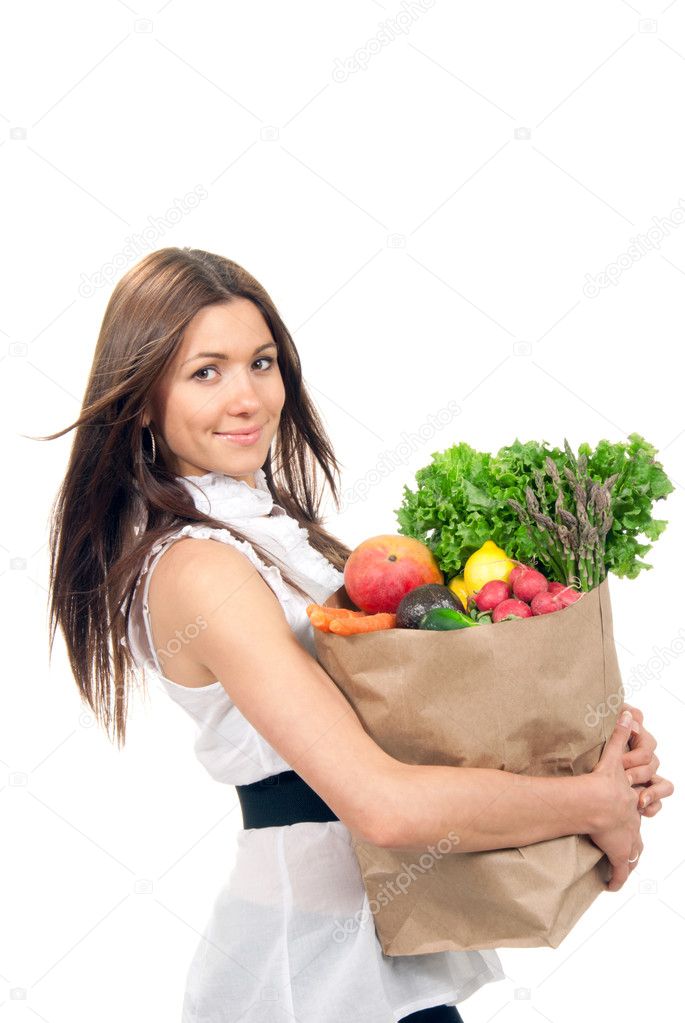 Woman holding a shopping bag full of vegetarian groceries
