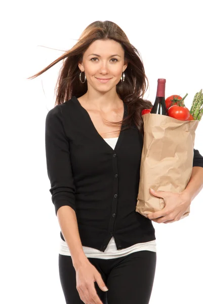 Woman holding a shopping bag full of vegetarian groceries — Stock Photo, Image