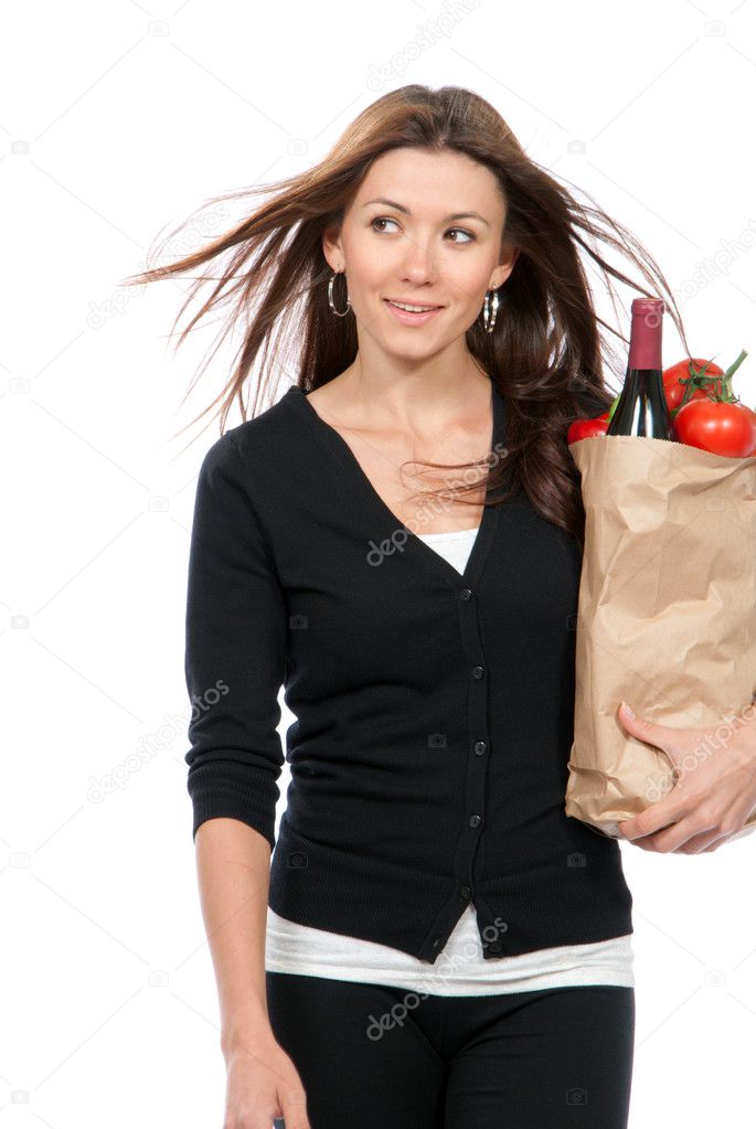 Woman holding a shopping bag full of vegetarian groceries