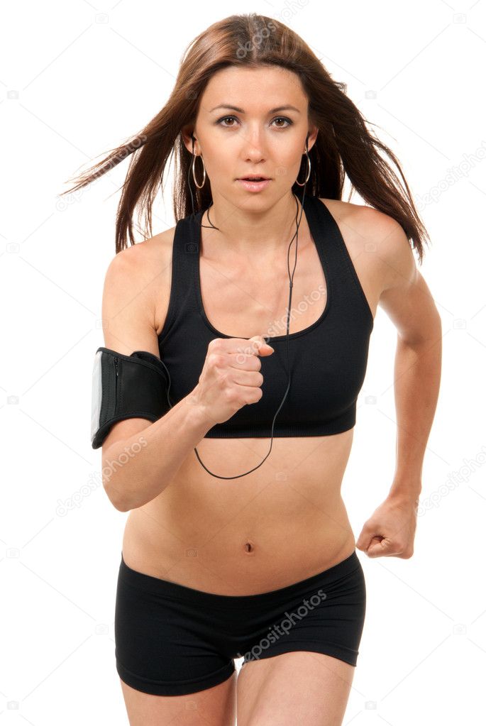 Slim brunette sport woman jogging and running, listening to musi