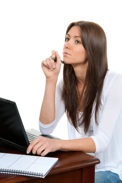 Pretty businesswoman thinking, with laptop on the table — Stock Photo, Image