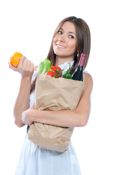 Woman holding a paper shopping bag full of groceries — Stock Photo, Image
