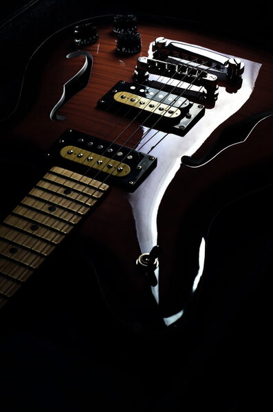 An artistic shot of a vintage hollow body electric guitar
