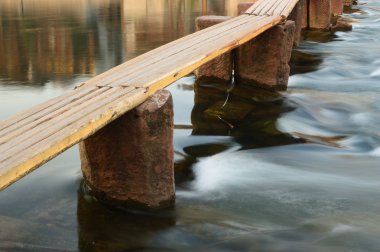 Wooden bridge on the river clipart