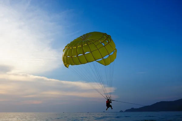 stock image Man parasailing at sunset