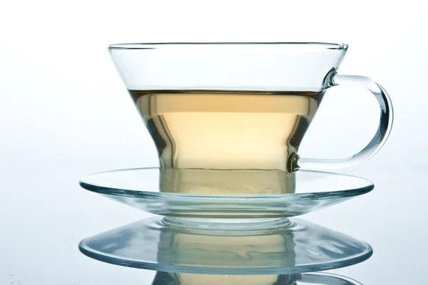 Glass cup of tea or another liquid with reflection — Stock Photo, Image