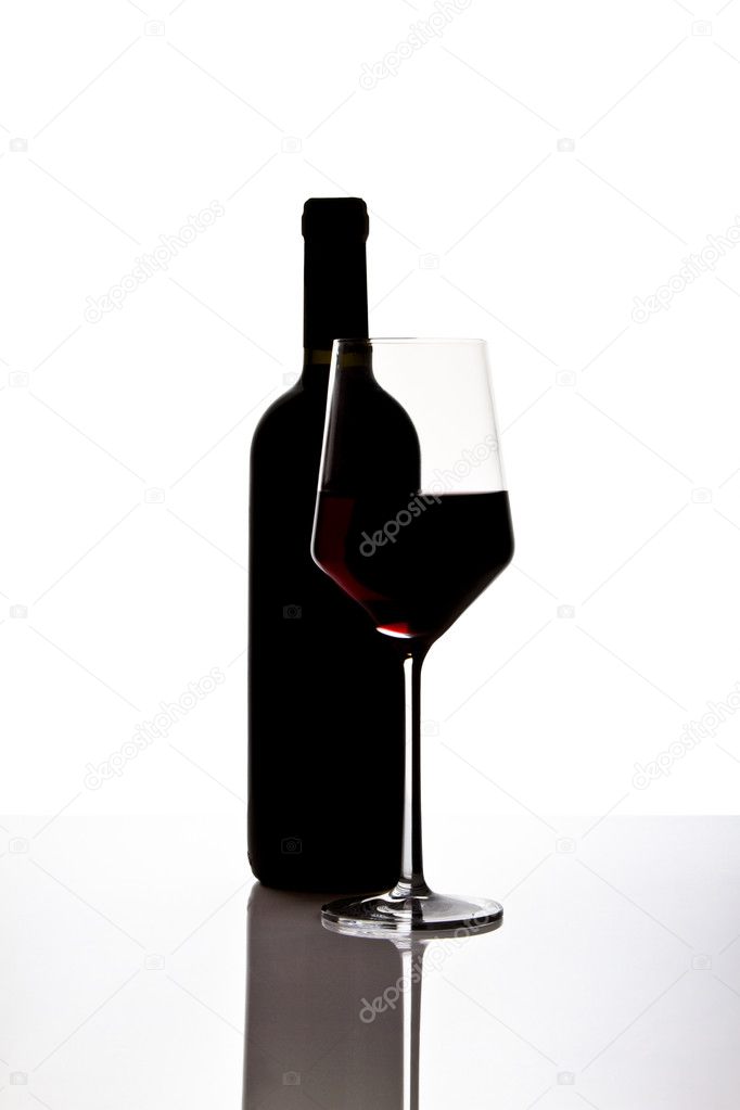 Bottle of red wine with half filled glass of wine