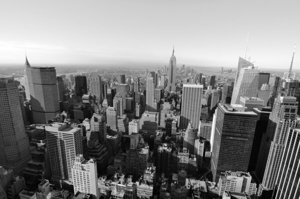 Black and white skyline of Manhattan looking towards downtown with landmark buildings.