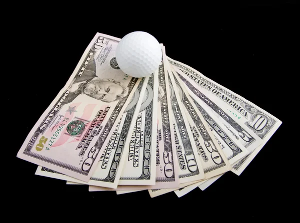 Stock image A ball for golf lies on dollar notes