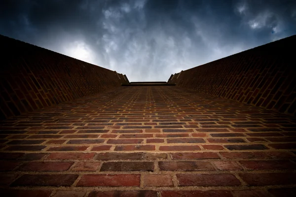 stock image Brick wall to dark sky