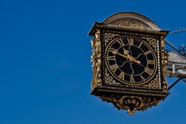 Ancient Clock Over A Blue Sky clipart