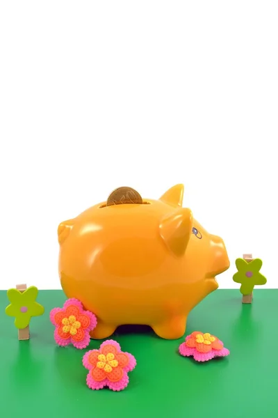 Piggy bank in toy garden — Stock Photo, Image