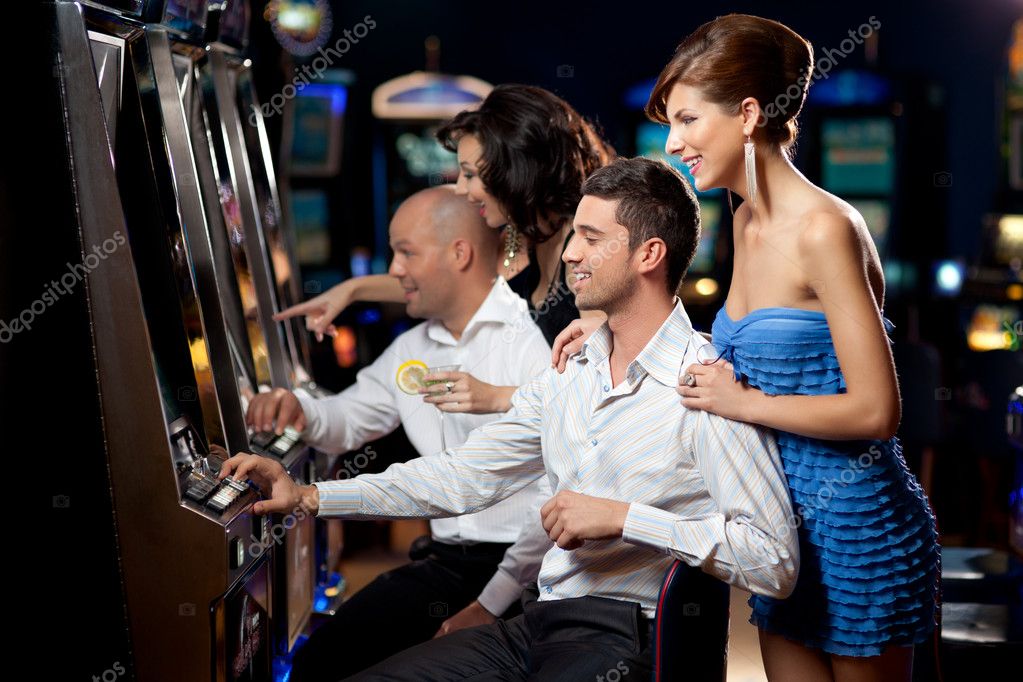 Friends playing the slots \u2014 Stock Photo \u00a9 shotsstudio #6111006