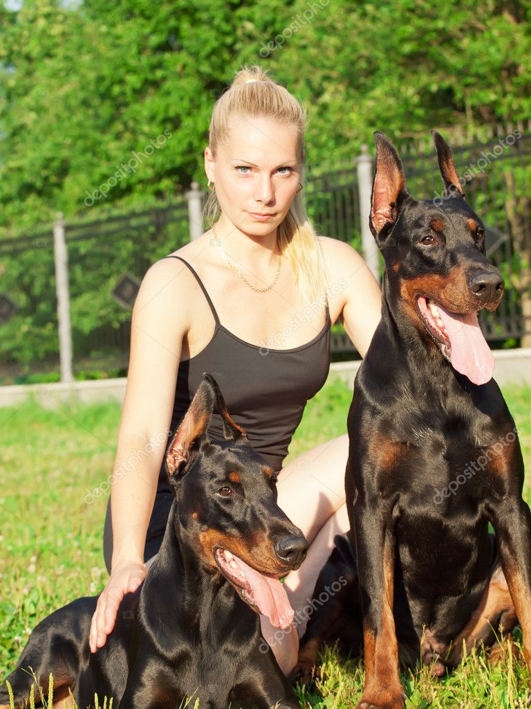 Pretty women with own dobermans — Stock Photo © anakondasp #6234672