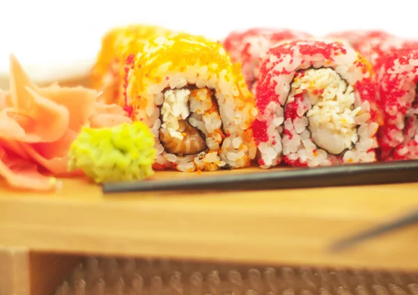 Laki sushi rolls at woody plate — Stock Photo, Image