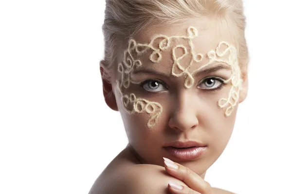 Blonde girl with a wool string on her face — Stock Photo, Image