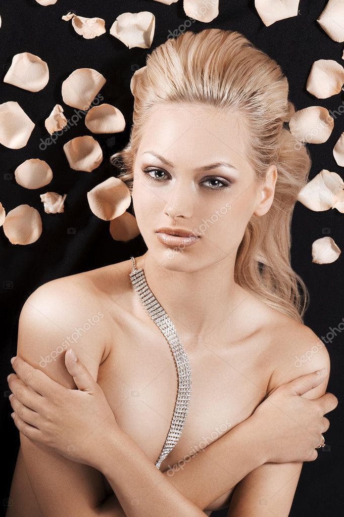 Laying naked blonde girl covering herself wearing a strass neckl Stock  Photo by ©carlodapino 6274643
