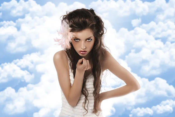 Model with feather accessory on white — Stock Photo, Image
