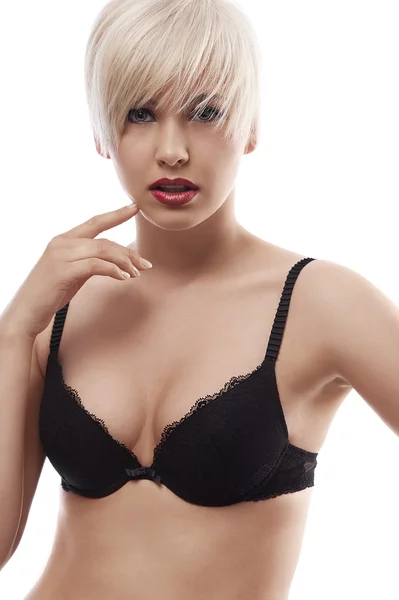 Blond sensuele meisje in lingerie tegen de witte achtergrond — Stockfoto