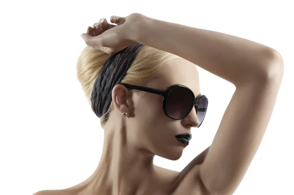 Fashion shot of blond girl with sunglasses posing against white — Stock Photo, Image