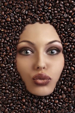 Portrait of a pretty girl laying among coffee beans clipart