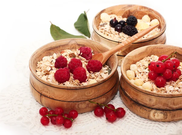 Wooden bowls with cereals and berries — Stock Photo, Image