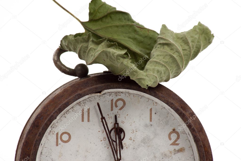 Autumn leave on old clock