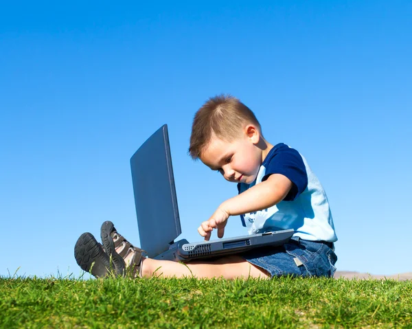 Little boy with laptop Stock Photo