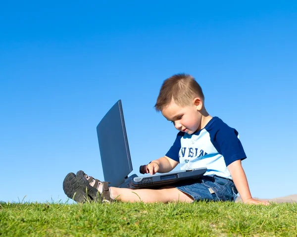 Little boy with laptop Stock Image