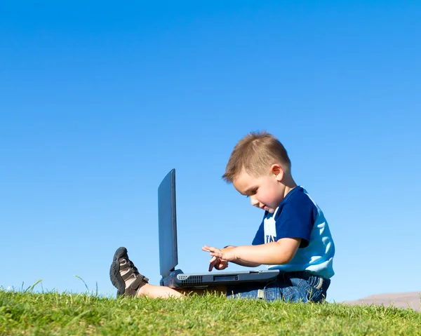 Little boy with laptop Royalty Free Stock Images