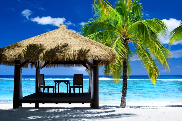 Tropical gazebo with chairs on amazing beach Royalty Free Stock Images