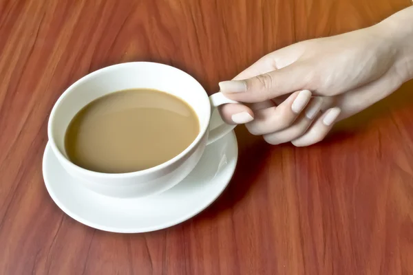 stock image Female hand with manicure holding a cup of coffee